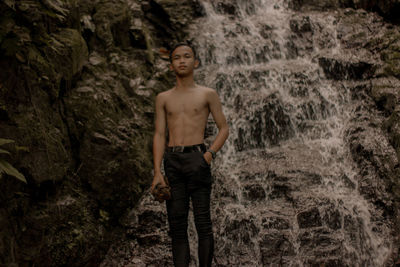 Young man standing on rock