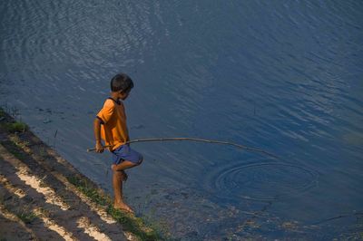 Rear view of boy on water