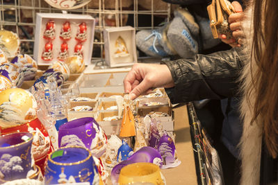 Midsection of woman having food at store