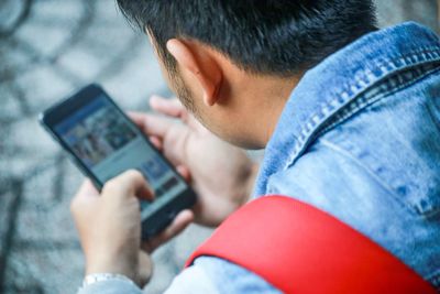 Midsection of man using mobile phone