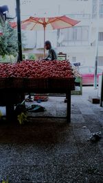 Rear view of woman with red umbrella in city