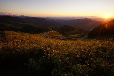 Scenic view of landscape against sky at sunset