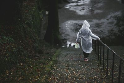 Rear view of girl walking in water