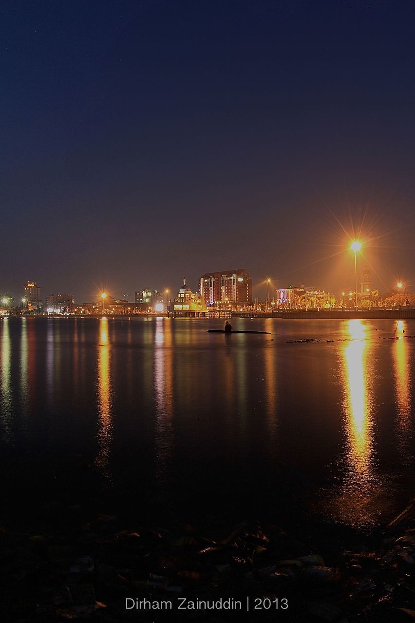 illuminated, night, water, architecture, built structure, building exterior, city, waterfront, river, reflection, clear sky, sky, copy space, cityscape, sea, bridge - man made structure, outdoors, no people, transportation, mid distance