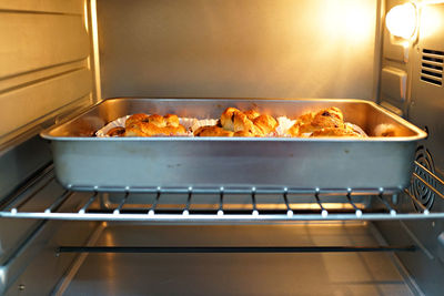 Chocolate pastries in baking tray on metal grate