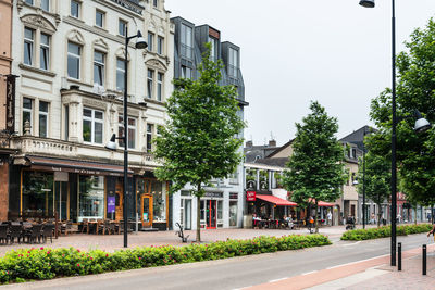 City street and buildings against sky