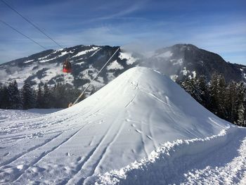 Scenic view of snow covered mountains against sky