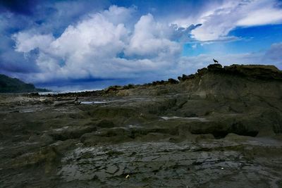 Scenic view of sea against cloudy sky