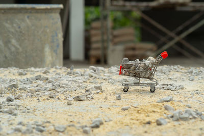 Selective focus on shopping trolley carries the crushed stones and pouring onto the pile at the site