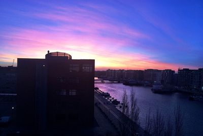 Buildings in city at sunset