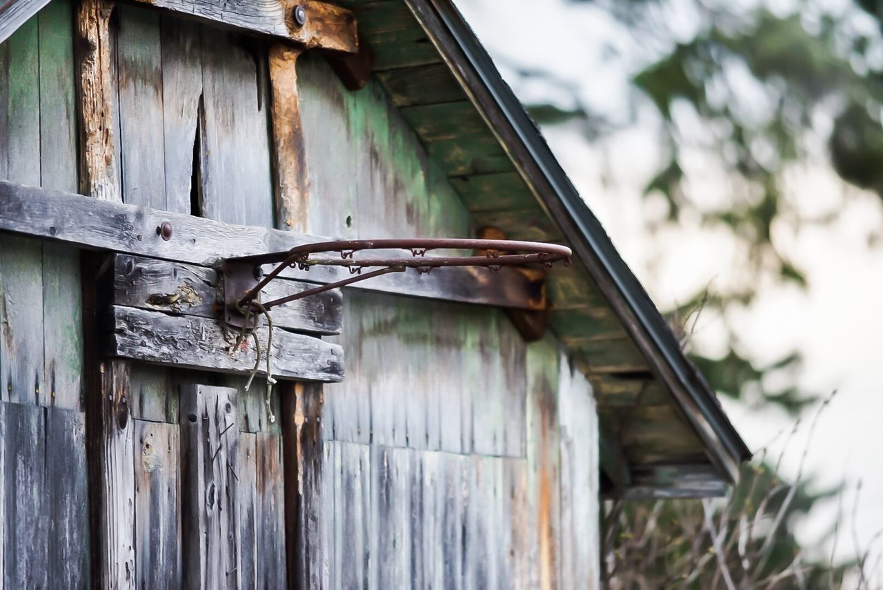 architecture, built structure, wood - material, house, day, building, building exterior, focus on foreground, no people, old, low angle view, outdoors, nature, abandoned, metal, weathered, entrance, close-up, damaged, run-down, corrugated