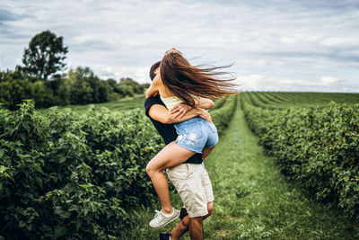 Young couple have fun on plant in land