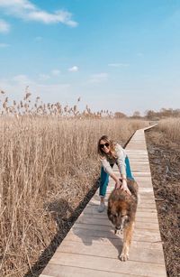 Full length of woman with dog standing on street