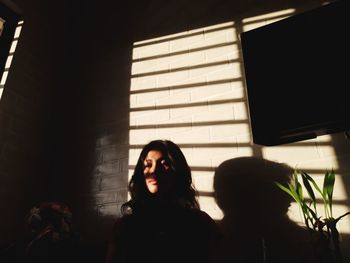 Young woman standing at home
