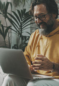 Young man using laptop at home