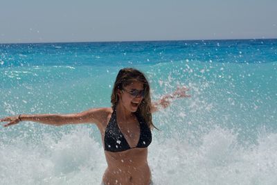 Happy young woman enjoying in sea