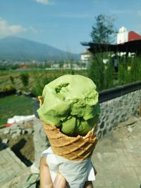 Person holding ice cream cone