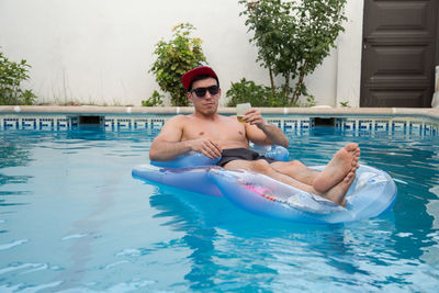 Portrait of shirtless man in swimming pool