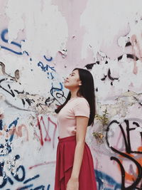 Woman standing against wall