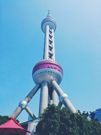 Low angle view of tower against blue sky