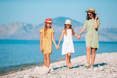 Full length of women standing on beach