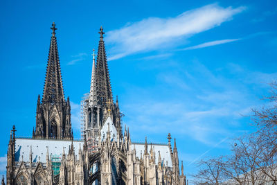 Low angle view of cologne cathedral against cloudy sky