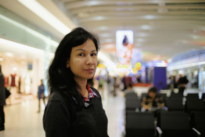 Portrait of young woman at heathrow airport