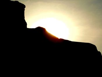 Silhouette of mountain against sky at sunset