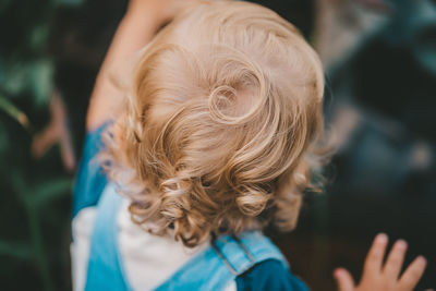 Close-up of boy head standing outdoors