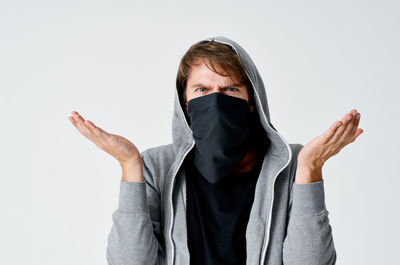 Portrait of man standing against white background