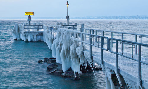 Jetty at calm sea during winter