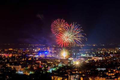 Low angle view of firework display against sky at night