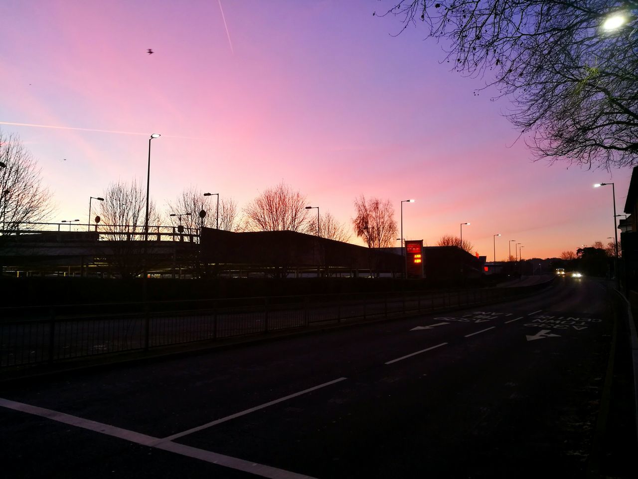 CARS ON STREET AGAINST SKY AT DUSK