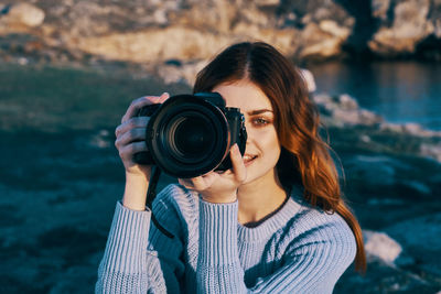 Portrait of woman photographing