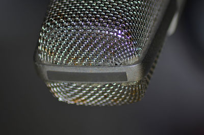 Close-up of metal grate against black background