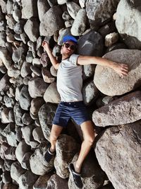 High angle view of man lying down on rocks