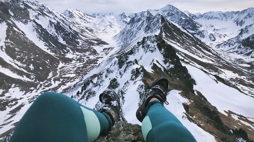 Low section of person on snowcapped mountain