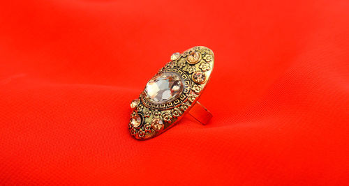 Close up of ring against red background