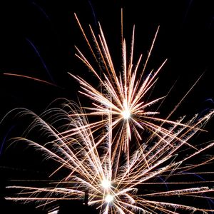 Low angle view of firework display at night