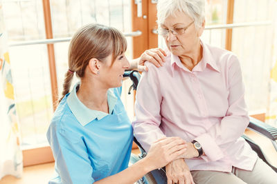 Midsection of woman sitting on table