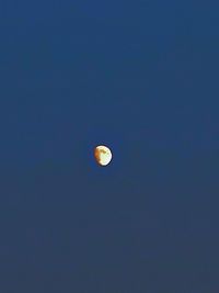 Low angle view of moon against sky at night