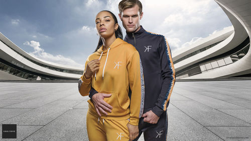 Young couple standing against sky