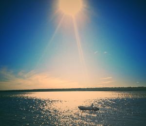 Scenic view of sea against sky on sunny day