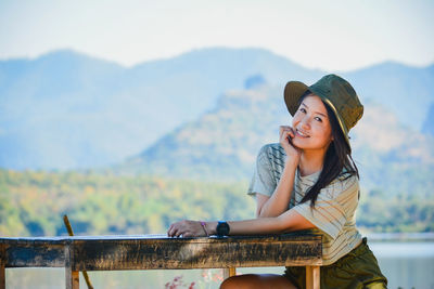 Young woman sitting on bench