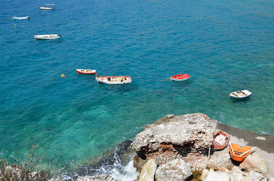 Small fishing boats floating in blue waters