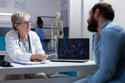 Doctor having discussion with patient at hospital