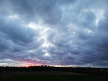 Scenic view of dramatic sky over field