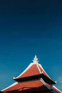 Low angle view of traditional building against blue sky