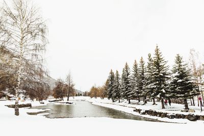 Snow covered landscape against clear sky