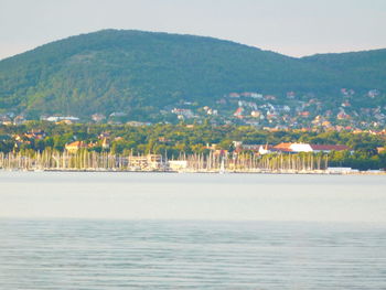 Scenic view of sea and town against sky